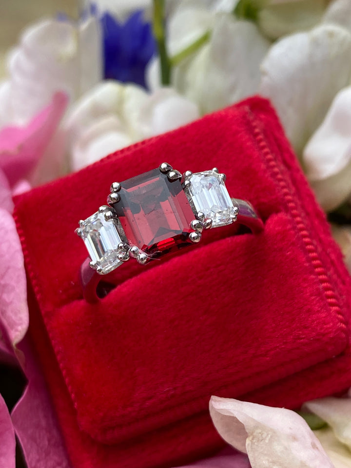 3.50 CTW Emerald Cut Garnet and Moissanite Three Stone Ring in Sterling Silver