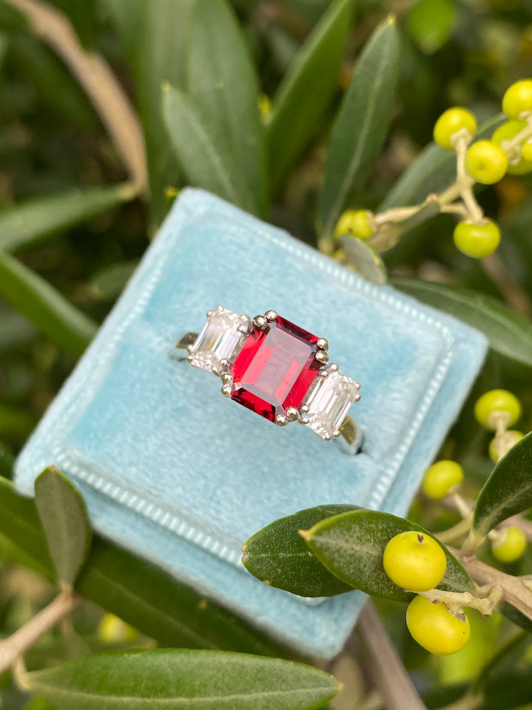 3.50 CTW Emerald Cut Garnet and Moissanite Three Stone Ring in Sterling Silver