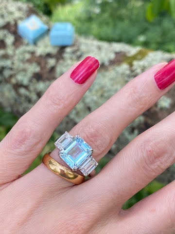 5.71 Carat Emerald Cut Blue Topaz and 2.00 Carat Moissanite Three Stone Ring in Sterling Silver