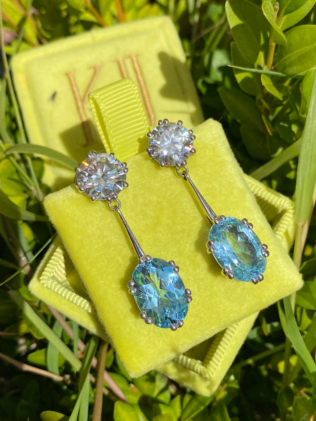21.60 CTW Oval Cut Blue Topaz and Moissanite Drop Earrings in Sterling Silver