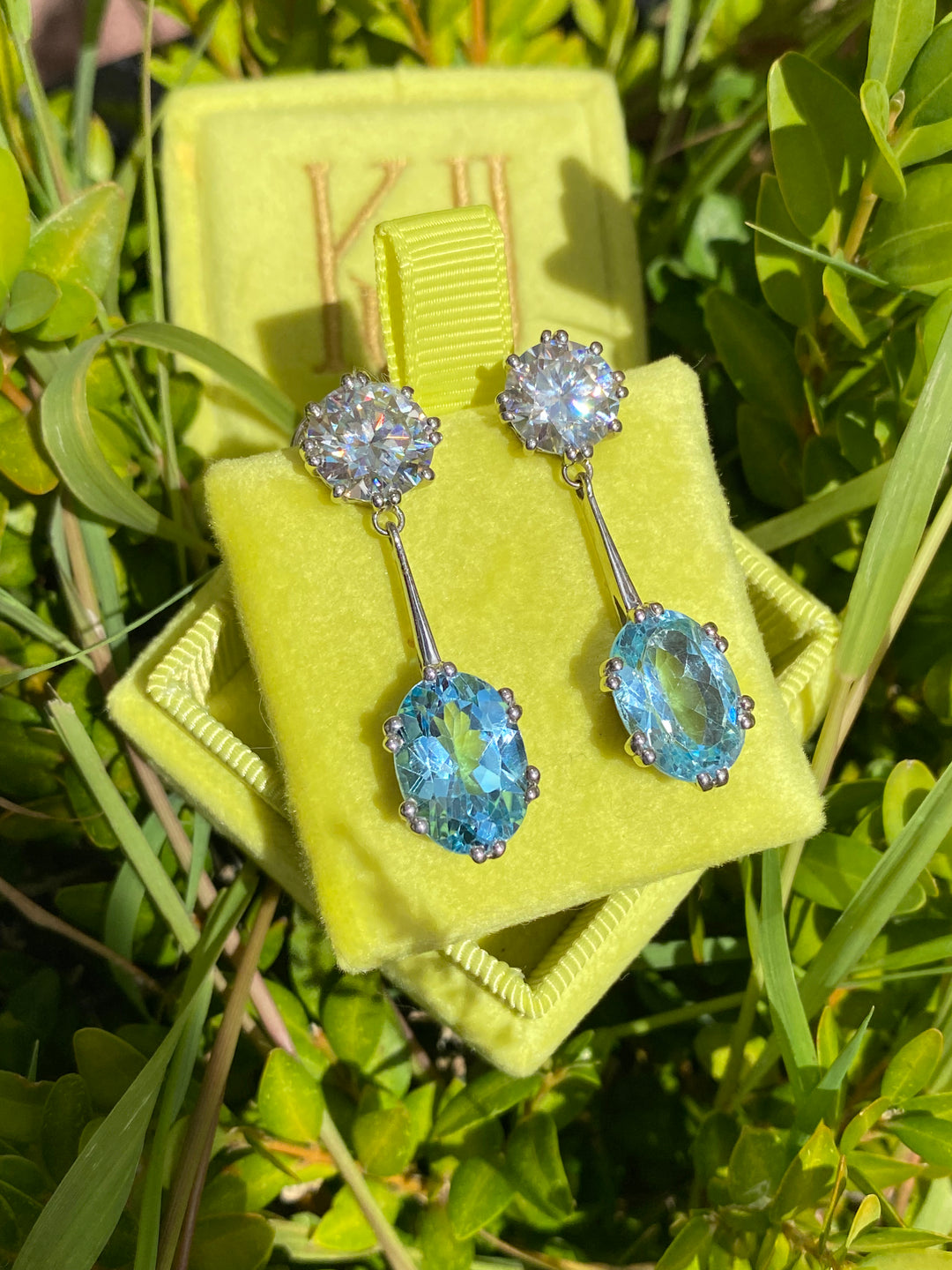 21.60 CTW Oval Cut Blue Topaz and Moissanite Drop Earrings in Sterling Silver
