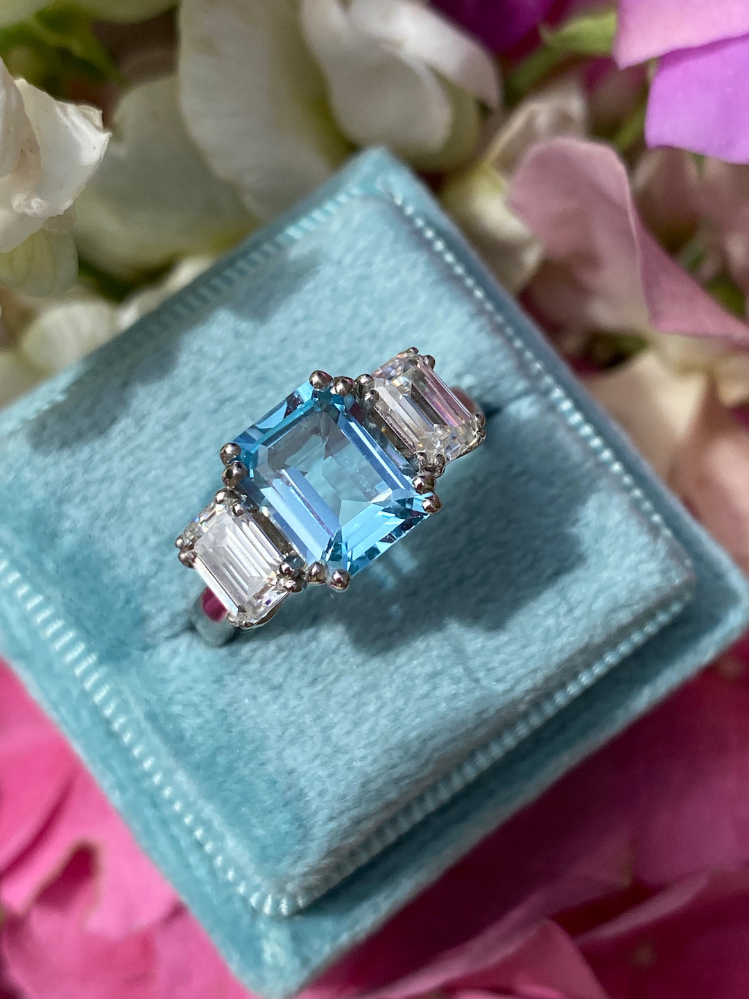 3.50 CTW Emerald Cut Blue Topaz and Moissanite Three Stone Ring in Sterling Silver