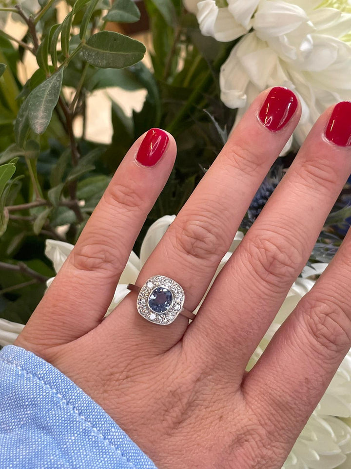 Cushion cut violet Blue Ceylon Sapphire and Diamond halo bezel engagement ring in Platinum